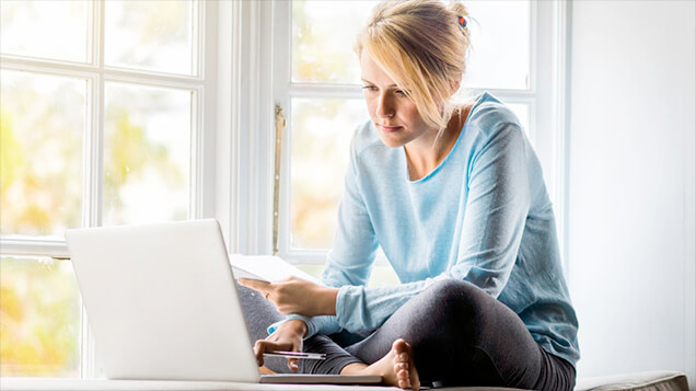 Woman on laptop looking for air conditioner