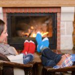 St. Louis couple next to fireplace