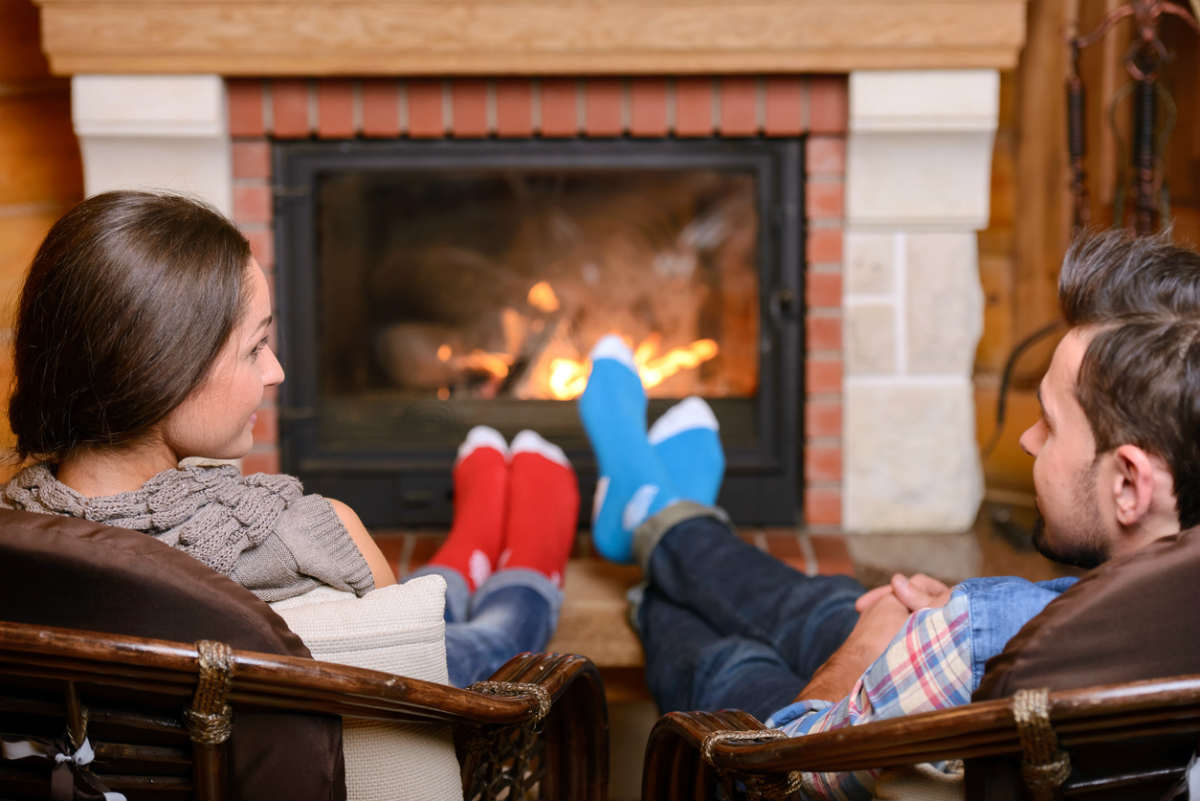 St. Louis couple next to fireplace