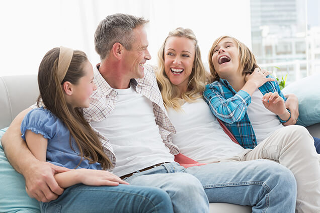Family laughing on the couch
