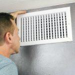 St. Louis man inspecting vent