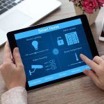 St. Louis woman adjusting thermostat from her tablet