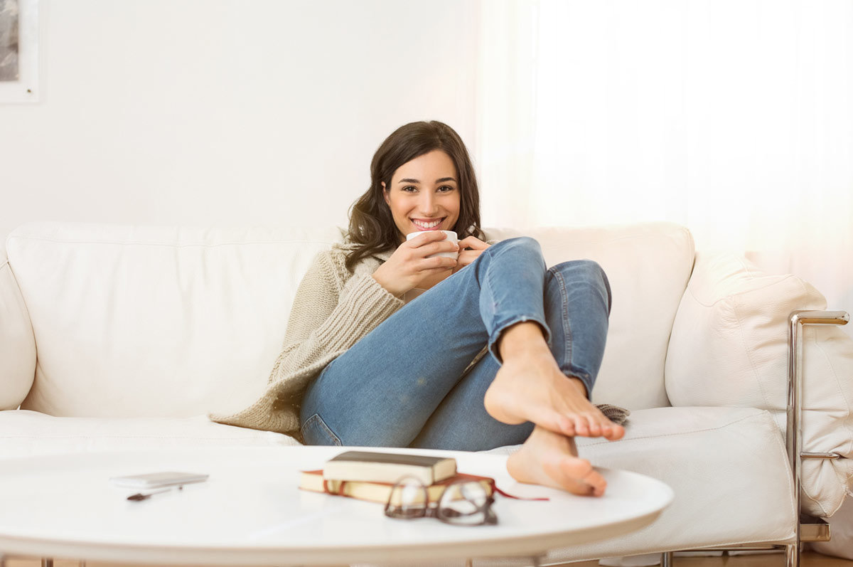 young, happy St. Louis woman on couch